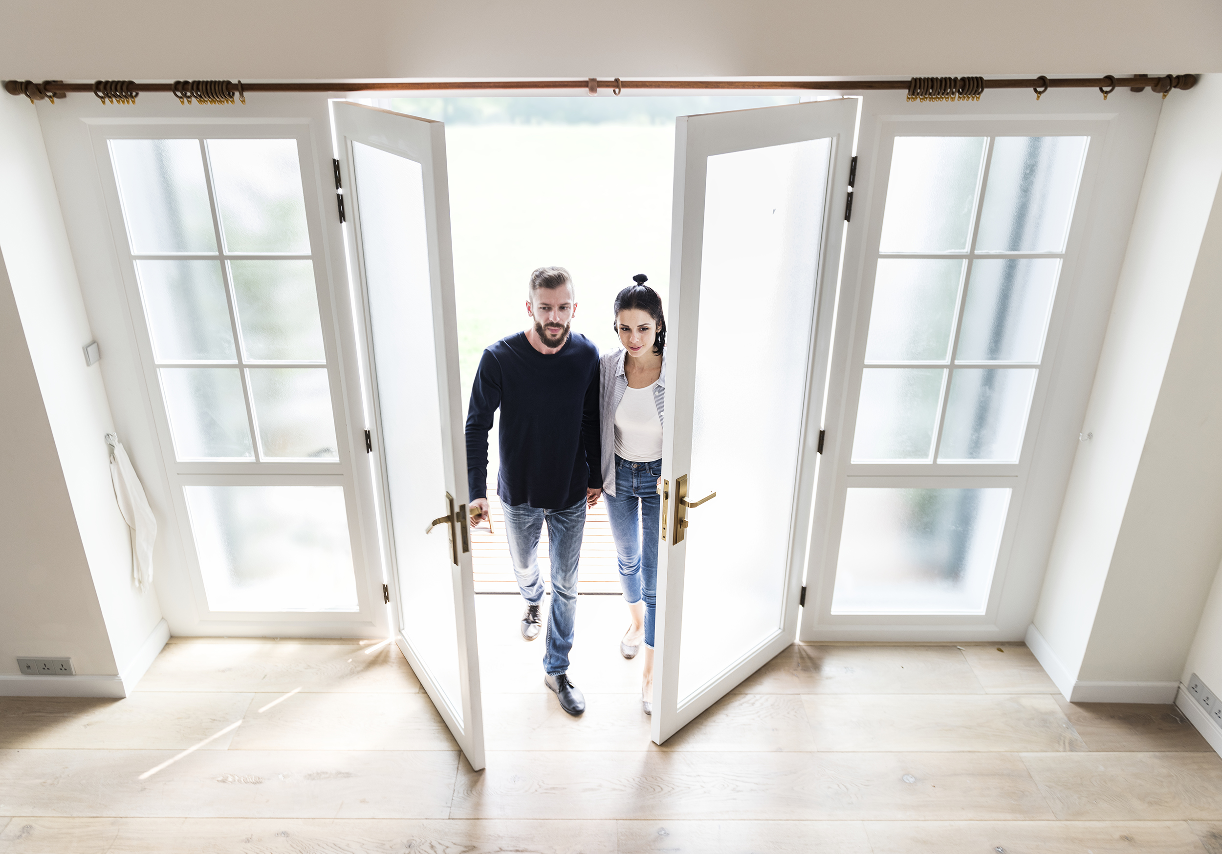 Couple walking into new home